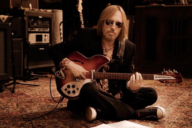 Tom Petty Sitting on the Floor with His Guitar